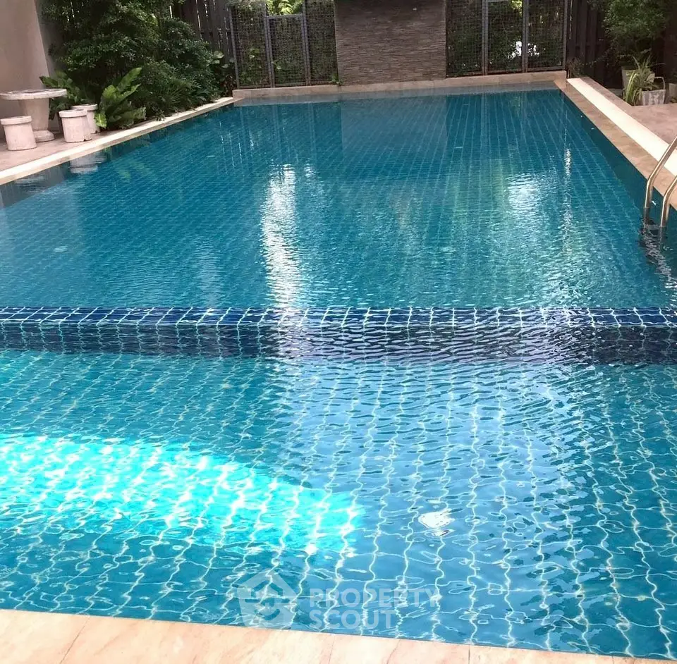 Luxurious swimming pool with crystal clear water and elegant surroundings.