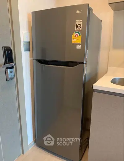 Modern kitchen with sleek stainless steel refrigerator and smart lock door