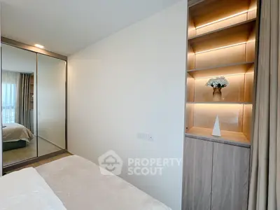 Modern bedroom with mirrored wardrobe and stylish built-in shelving