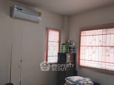 Cozy bedroom with air conditioning and ample storage space.