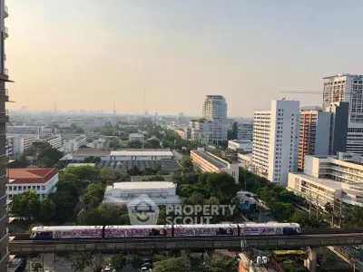 Stunning cityscape view from high-rise building with urban skyline and train track.