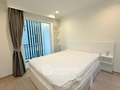 Modern minimalist bedroom with balcony access and elegant curtains