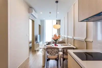 Modern open-layout kitchen and dining area with elegant decor and natural light.