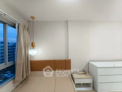 Modern minimalist bedroom with stylish pendant light and ample natural light