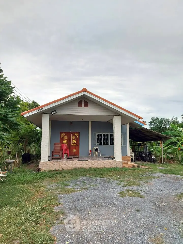 Charming single-story house with a spacious front yard and inviting porch.