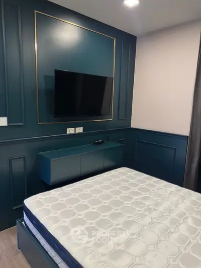 Modern bedroom with sleek TV and elegant paneling