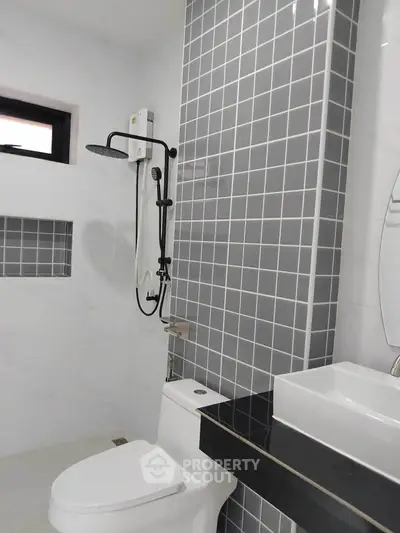 Modern bathroom with sleek gray tiles and contemporary fixtures
