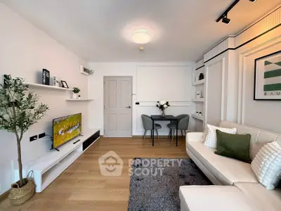 Modern living room with stylish decor, featuring a cozy sofa, wall-mounted TV, and elegant dining area.