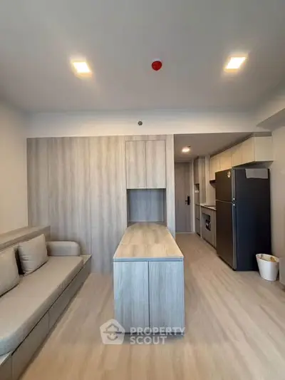 Modern kitchen and living area with sleek design and integrated appliances
