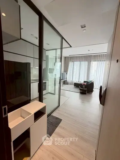 Modern living room with glass partition and sleek design