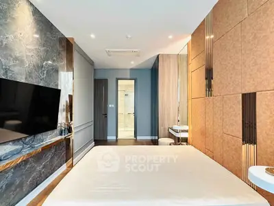 Luxurious modern bedroom with stylish decor and wall-mounted TV