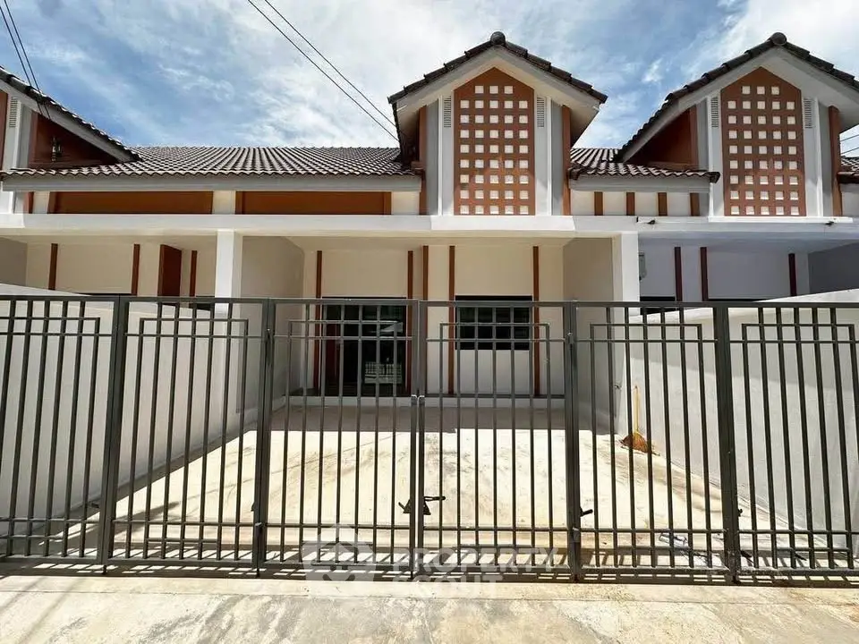 Charming townhouse with gated entrance and modern architectural design.