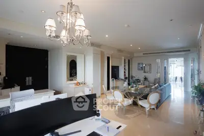 Luxurious open-plan living room with elegant chandelier and modern decor