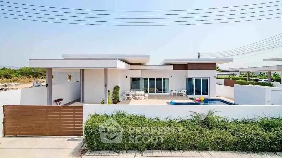 Modern single-story home with pool and spacious patio in a serene neighborhood.
