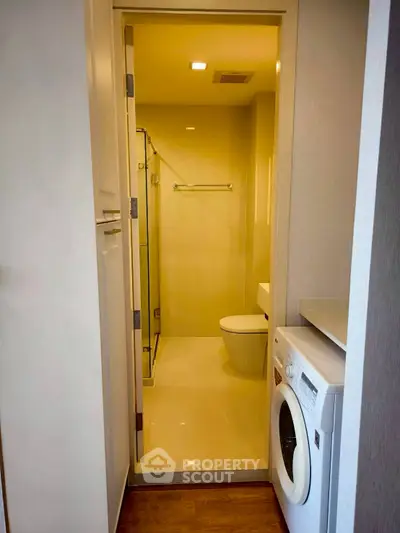 Compact bathroom with washing machine in modern apartment
