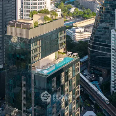 Luxurious high-rise building with rooftop pool and stunning city views, perfect for urban living.