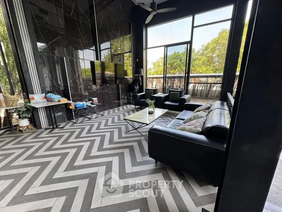 Luxurious living room with modern decor and large windows offering a stunning view.