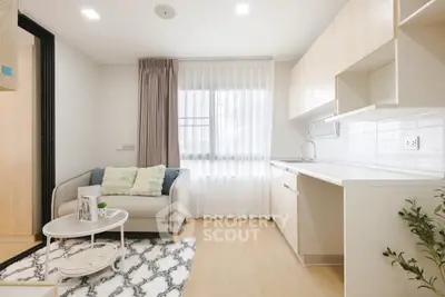 Modern living room with cozy sofa and stylish kitchen in open layout