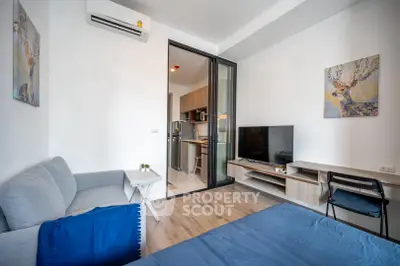 Modern studio apartment with open layout, featuring cozy living area and sleek kitchen design.