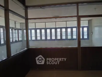 Spacious interior with large windows and natural light, ideal for office or study space.