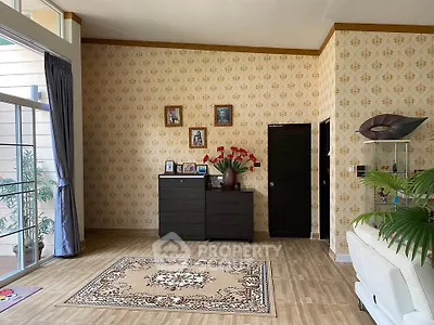 Spacious living room with elegant wallpaper and large window
