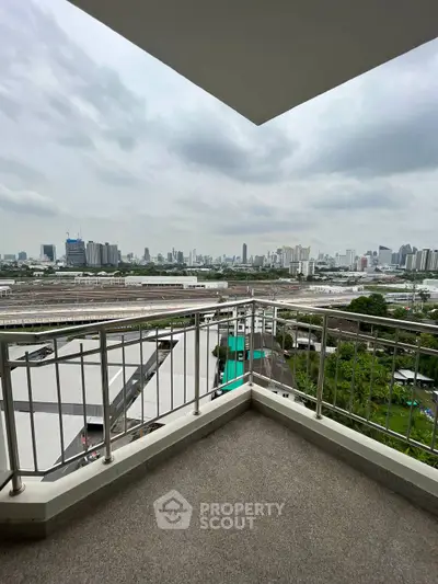 Spacious balcony with stunning city skyline view, perfect for relaxation and enjoying urban scenery.