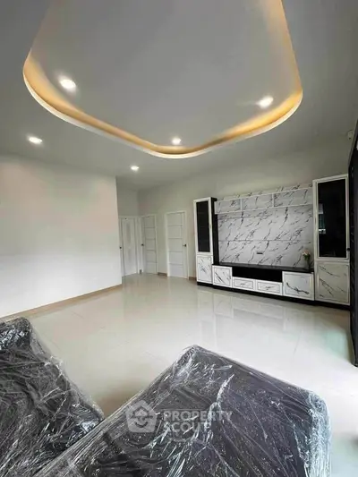 Modern living room with sleek marble accents and recessed lighting