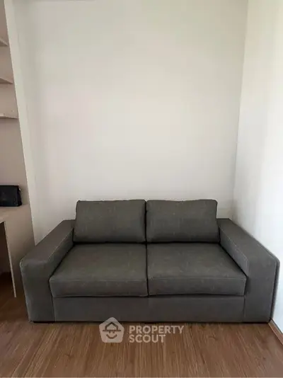 Cozy living room with modern gray sofa and wooden flooring