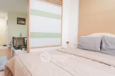 Cozy bedroom with soft bedding and modern decor, perfect for relaxation.