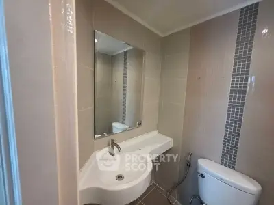 Modern bathroom with sleek sink and neutral tiles