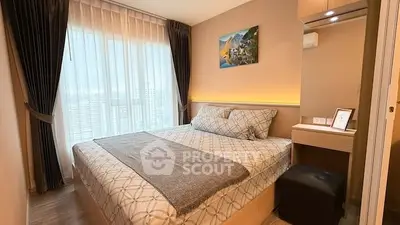 Cozy bedroom with modern decor and large window offering city views.