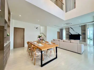 Spacious modern living room with elegant dining area and stylish decor