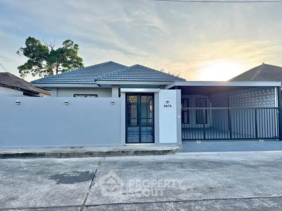 Charming single-story home with modern facade and spacious driveway in a serene neighborhood.