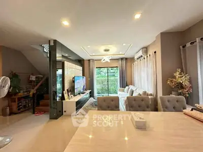 Spacious modern living room with elegant decor and large windows for natural light.