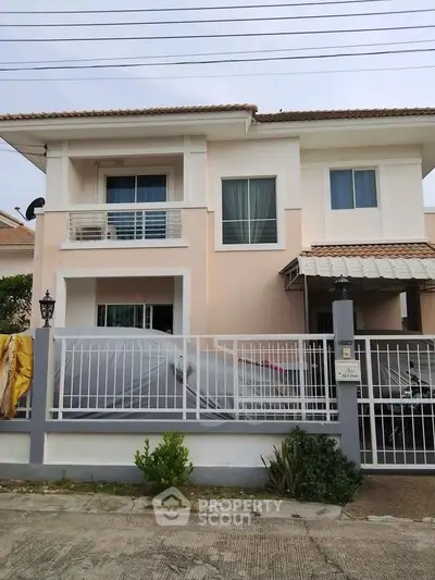 Charming two-story house with gated driveway and modern facade in a serene neighborhood.