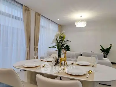 Elegant dining area with modern decor and natural light in a luxurious living room.