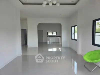 Spacious modern living room with open layout and sleek tile flooring