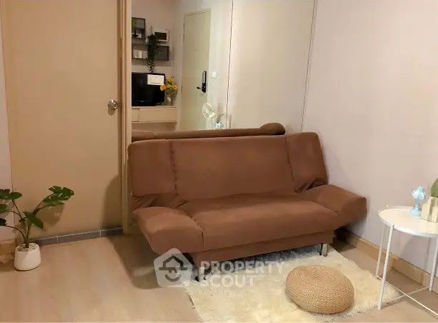 Cozy living room with brown sofa and modern decor in a stylish apartment.