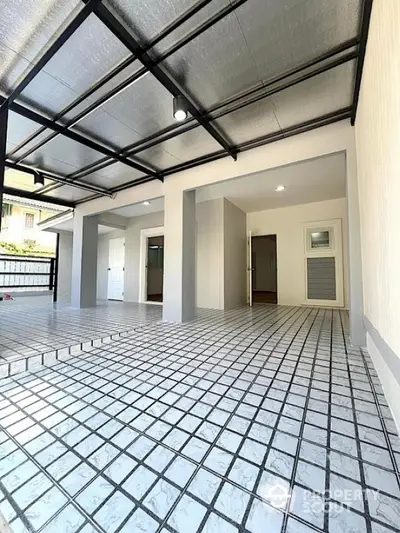 Modern covered parking area with tiled flooring and open layout