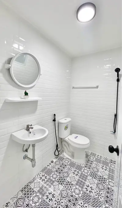 Modern bathroom with stylish tiles and round mirror