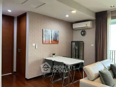 Modern living room with dining area, air conditioning, and stylish decor in a cozy apartment.