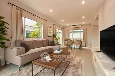 Spacious modern living room with elegant decor and natural light, perfect for relaxation and entertaining.