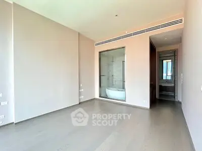 Spacious modern bedroom with ensuite bathroom and large window