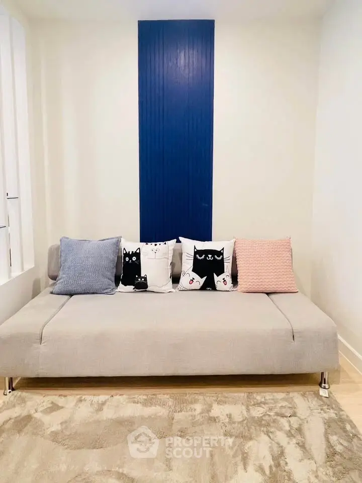 Chic living room with modern sofa and stylish decor pillows in a cozy apartment.