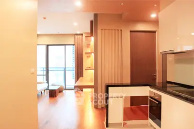 Modern open-layout apartment with sleek kitchen and spacious living area, featuring floor-to-ceiling windows.