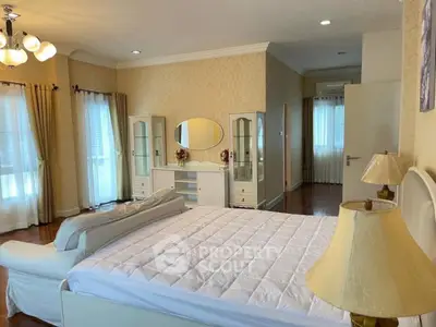 Spacious bedroom with elegant decor and natural light