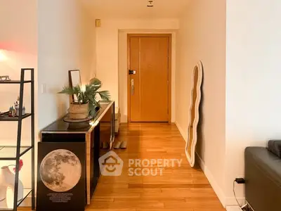 Stylish apartment entrance with wooden flooring and modern decor