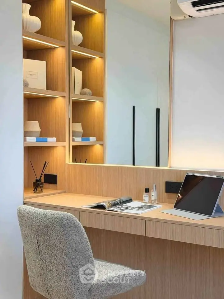 Modern study area with built-in shelves and sleek desk in a stylish apartment.