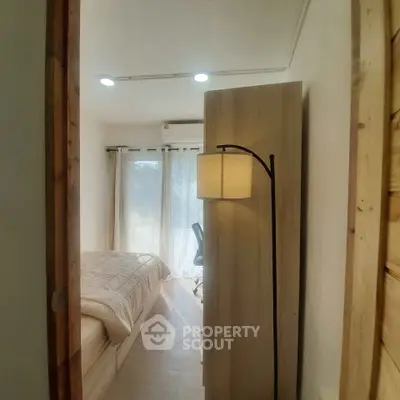 Cozy bedroom with natural light and modern decor, perfect for relaxation.