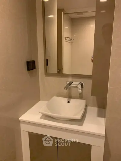 Modern bathroom with sleek sink and mirror in elegant design